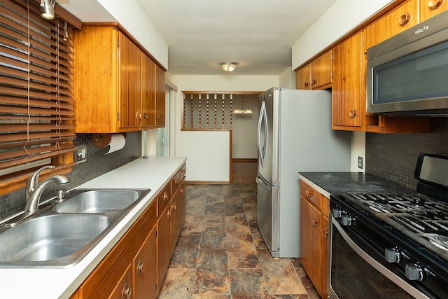 kitchen featuring sink, tasteful backsplash, and black gas range oven