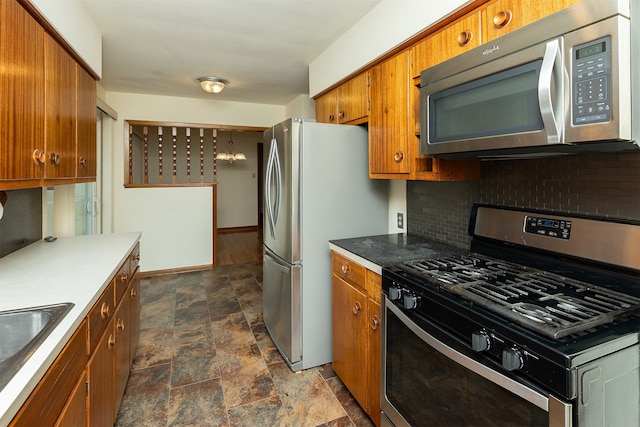 kitchen with sink, decorative backsplash, and stainless steel appliances