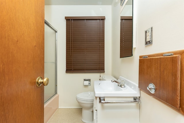 full bathroom featuring vanity, enclosed tub / shower combo, and toilet