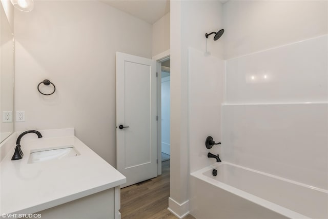 bathroom with shower / bathing tub combination, vanity, and wood-type flooring