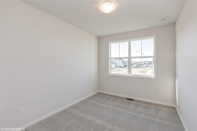 unfurnished room with light colored carpet