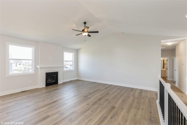 unfurnished living room with lofted ceiling, ceiling fan, and light wood-type flooring