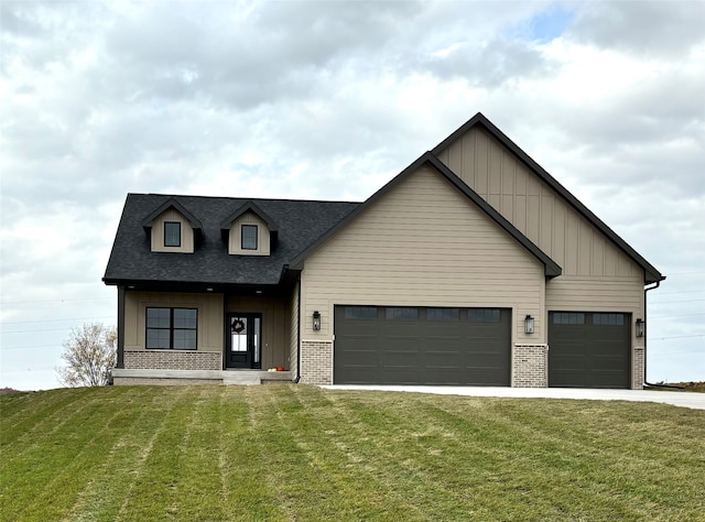 view of front of home with a front yard and a garage