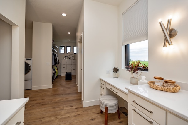 bathroom with washer / clothes dryer, hardwood / wood-style floors, and a healthy amount of sunlight