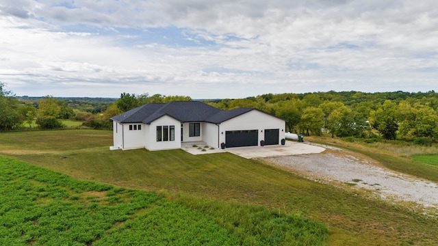 view of front of home featuring a garage and a front lawn