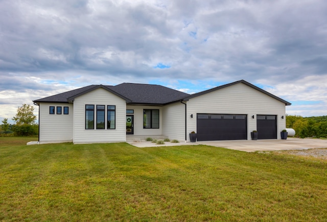 view of front of property with a front yard and a garage