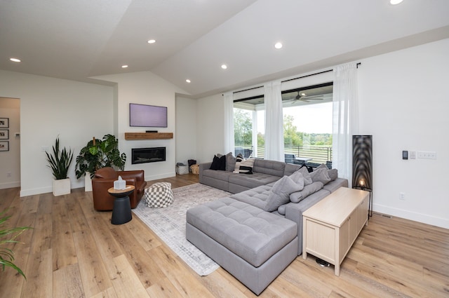 living room with vaulted ceiling and light hardwood / wood-style floors