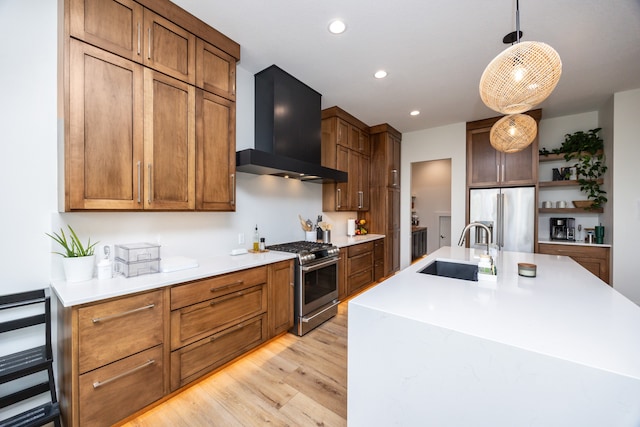 kitchen featuring pendant lighting, light wood-type flooring, sink, custom exhaust hood, and high quality appliances