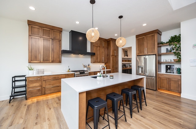 kitchen with sink, light hardwood / wood-style flooring, a center island with sink, high quality appliances, and premium range hood