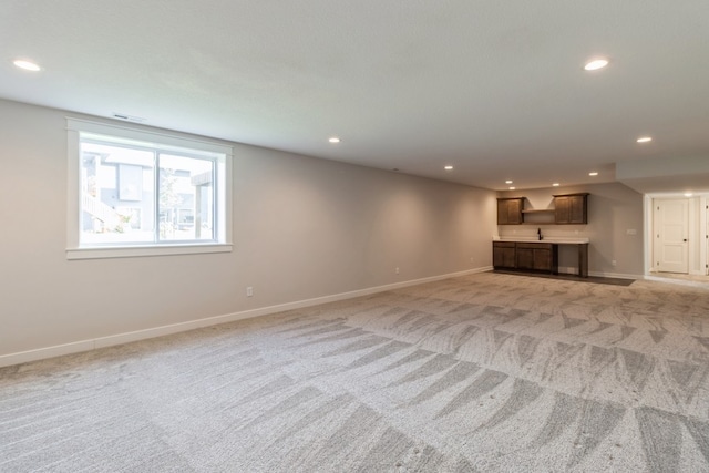 unfurnished living room featuring light carpet