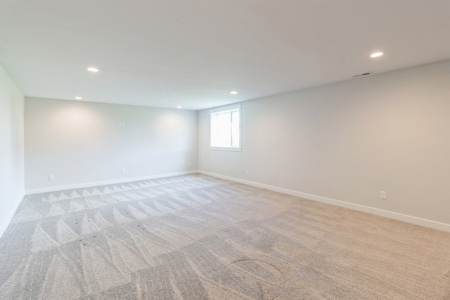 unfurnished room with light carpet