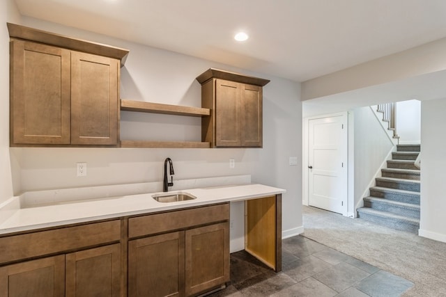 kitchen featuring dark colored carpet and sink