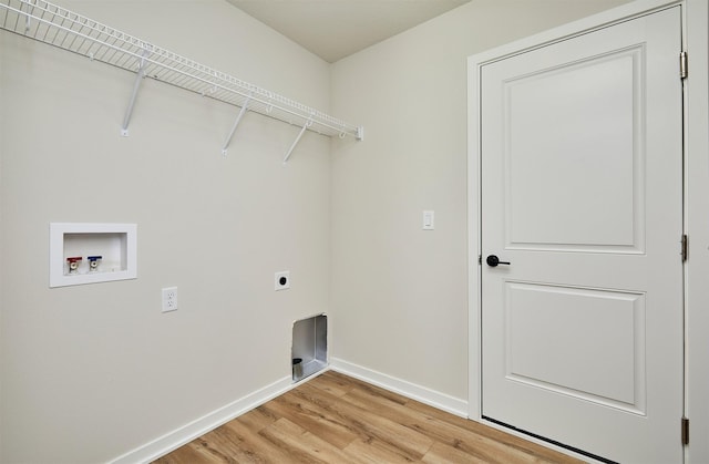 washroom featuring electric dryer hookup, light hardwood / wood-style floors, and hookup for a washing machine