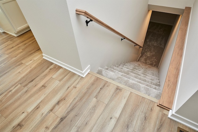 stairs featuring hardwood / wood-style floors