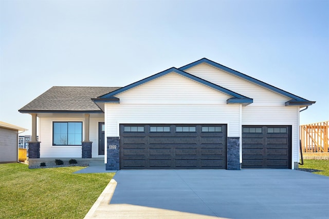 modern inspired farmhouse featuring a garage and a front yard