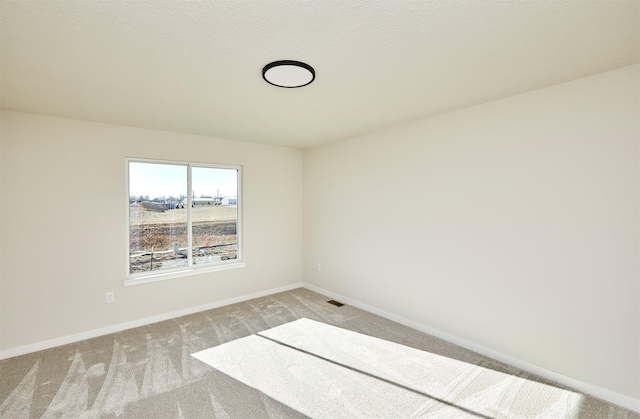 empty room featuring light colored carpet