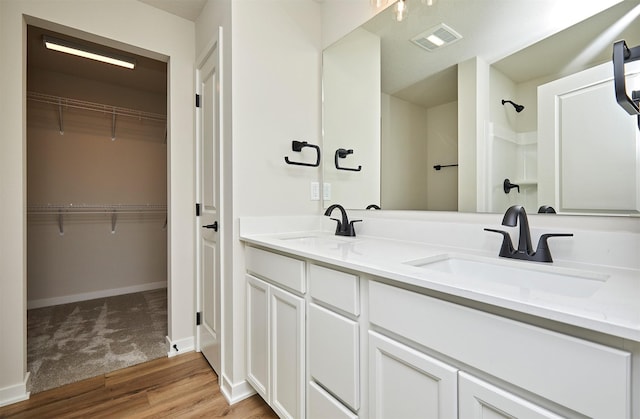 bathroom with hardwood / wood-style flooring and vanity