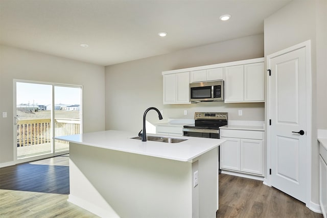 kitchen featuring sink, an island with sink, white cabinets, and appliances with stainless steel finishes