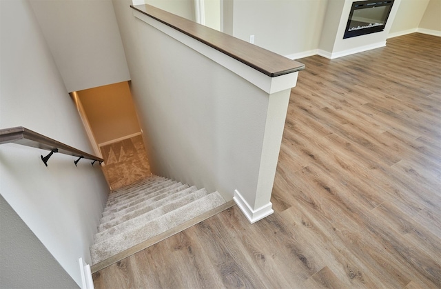 stairway featuring hardwood / wood-style flooring