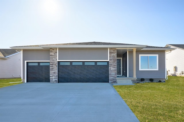 prairie-style home with a garage and a front lawn