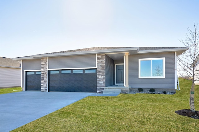 view of front of house with a garage and a front lawn