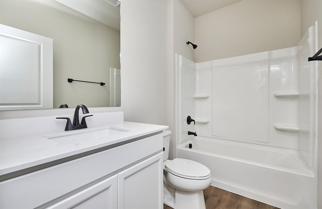 full bathroom featuring vanity, toilet, hardwood / wood-style floors, and shower / bathing tub combination