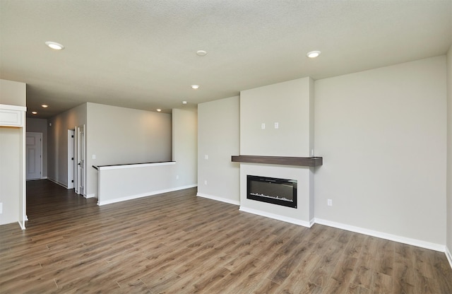 unfurnished living room featuring dark hardwood / wood-style floors