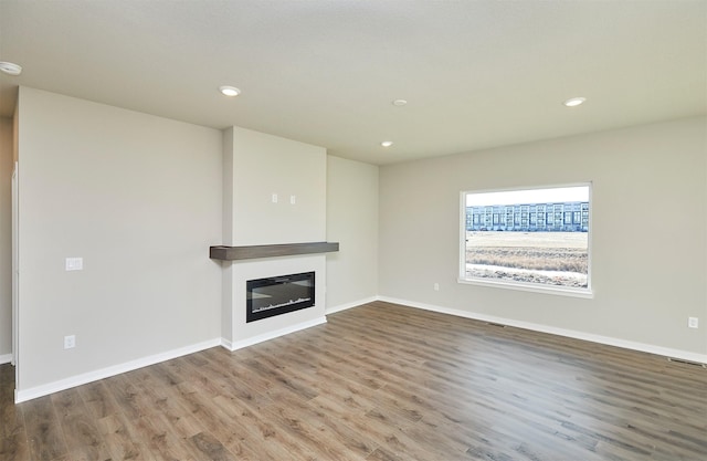 unfurnished living room with hardwood / wood-style flooring