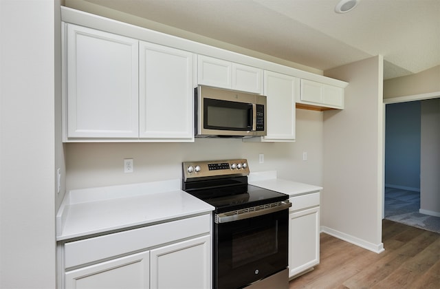 kitchen featuring white cabinetry, stainless steel appliances, and light hardwood / wood-style flooring