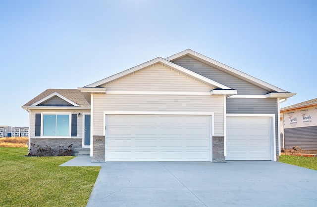 view of front of home with a garage and a front lawn