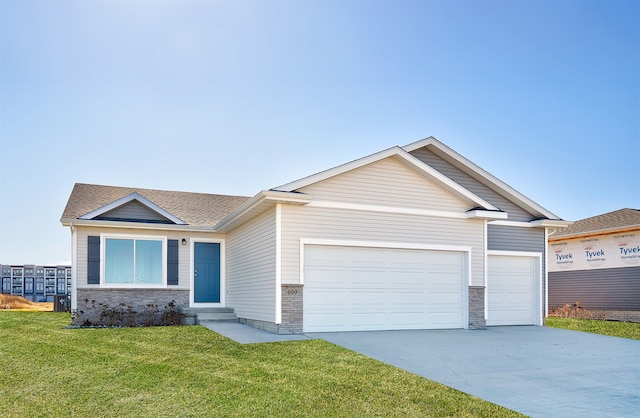 view of front of home with a garage and a front lawn