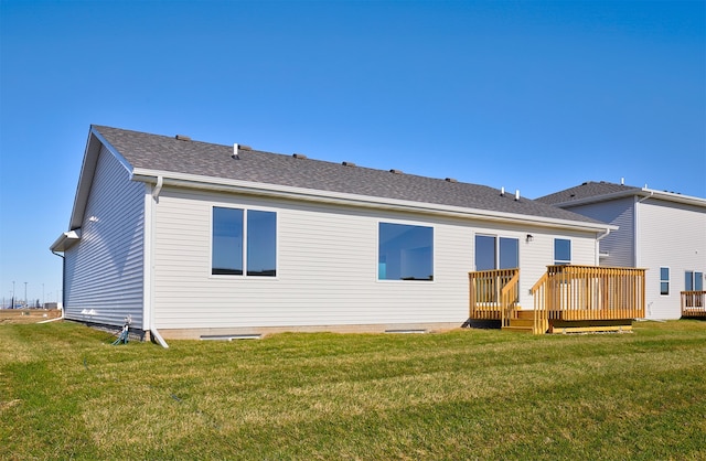 back of house featuring a deck and a lawn