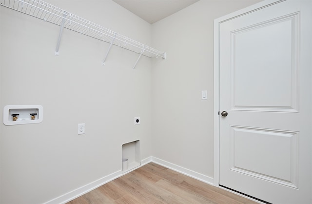 laundry room with hookup for a washing machine, electric dryer hookup, and light hardwood / wood-style flooring