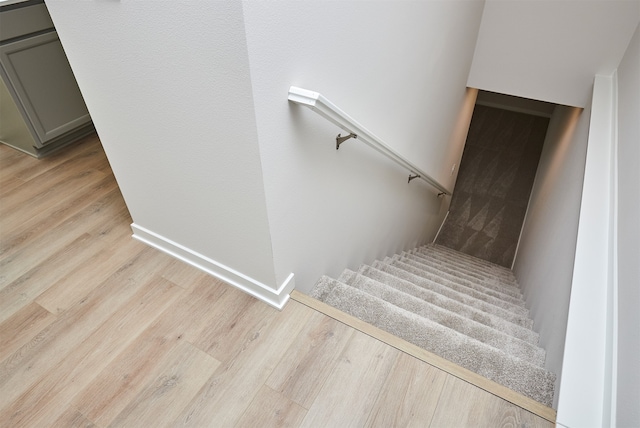 staircase with hardwood / wood-style flooring