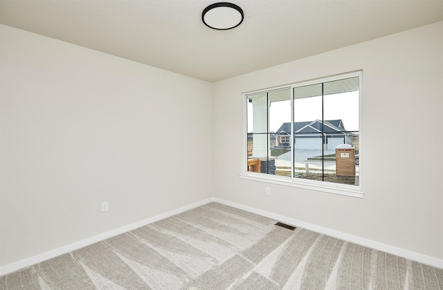 spare room featuring carpet floors