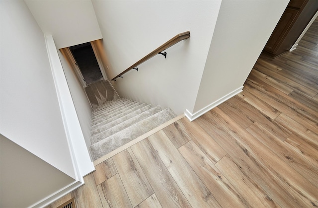 stairs with hardwood / wood-style floors