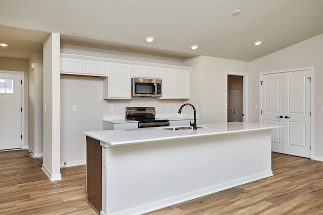 kitchen with white cabinets, sink, an island with sink, and appliances with stainless steel finishes