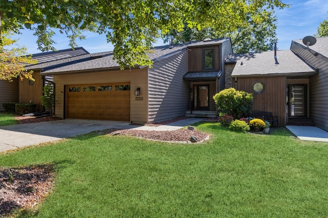 view of front facade with a front yard and a garage