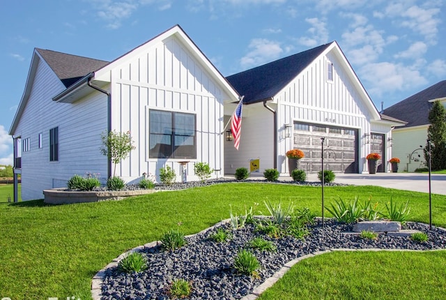 modern farmhouse featuring a front yard and a garage