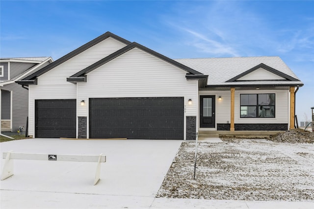 view of front of house featuring a porch and a garage