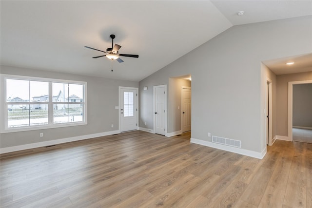 unfurnished living room featuring ceiling fan, light wood-type flooring, and vaulted ceiling