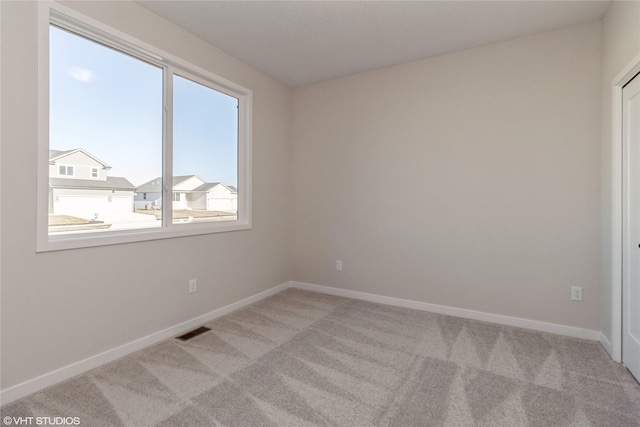 spare room with light colored carpet