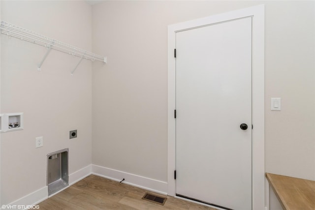 clothes washing area featuring electric dryer hookup, washer hookup, and light wood-type flooring