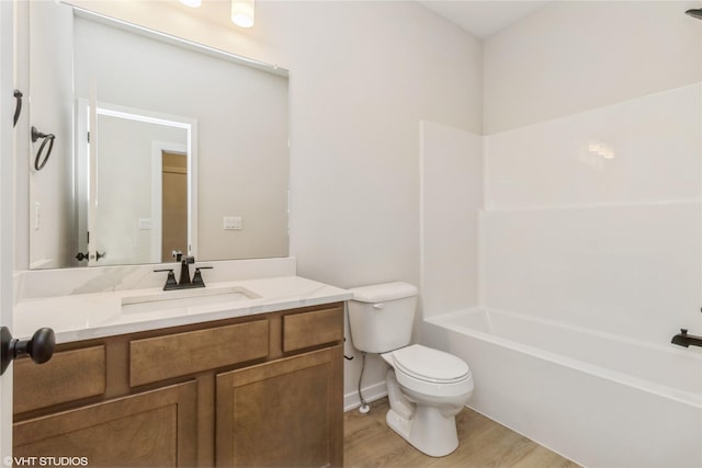 full bathroom with hardwood / wood-style flooring, vanity, toilet, and bathing tub / shower combination