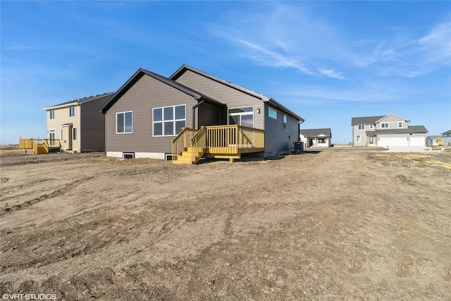 rear view of house featuring a deck