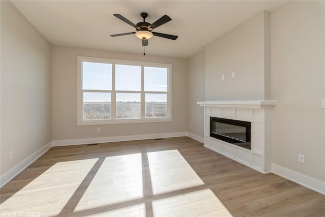 unfurnished living room featuring light wood-type flooring and ceiling fan