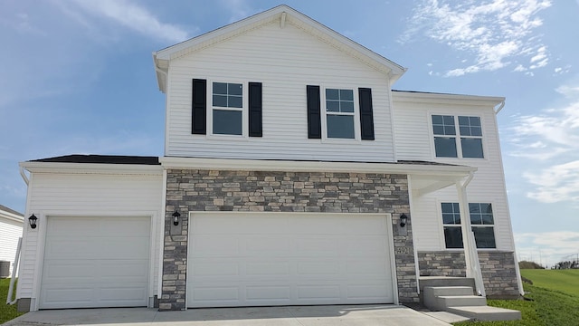 view of front of property with cooling unit and a garage