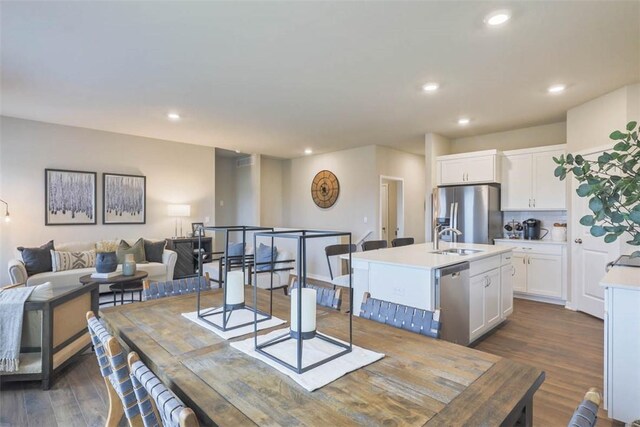 dining space with dark hardwood / wood-style flooring and sink