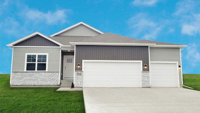 view of front of property featuring a garage and a front lawn