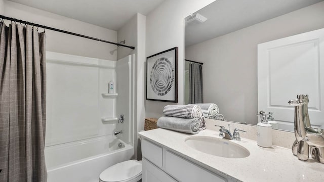 full bathroom featuring shower / bath combo, vanity, and toilet